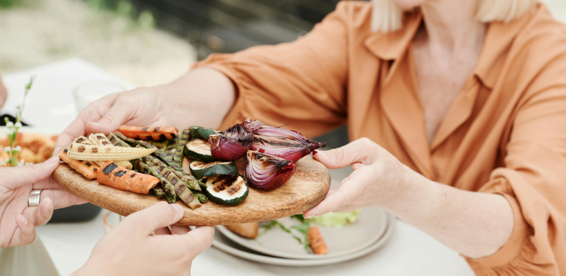 Nasmejana ženska z zdravo prehrano, ki podpira metabolizem in energijo.